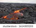 Hot magma of an active lava flow emerges from a fissure, the heat of the glowing lava makes the air flicker, the lava cools down slowly and solidifies - Hawaii, Big Island, Kilauea volcano, Kalapana