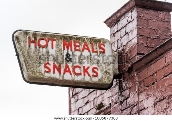 Hot\
Meals and Snacks logo sign on cafe pub bar brick\
wall