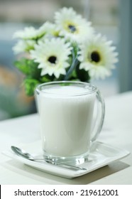 Hot milk in a glass with Flowers