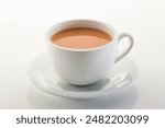 Hot milk tea ir chai served in cup isolated on grey background side view of chinese hot drink