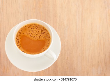 Hot Milk Tea In A White Cup On Wooden Background