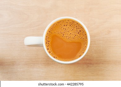 Hot Milk Tea In A White Cup On Wooden Table