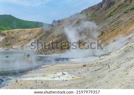 hot mineralized lake with thermal spring and smoking fumaroles in the caldera of the Golovnin volcano on the island of Kunashir
