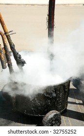 Hot Molten Tar Pours Into A Hot Tar Bucket On A Roof