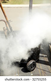 Hot Molten Tar Pours Into A Hot Tar Bucket On A Roof