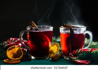 Hot Mulled Wine In The Glass Mug On A Dark Background With Steam