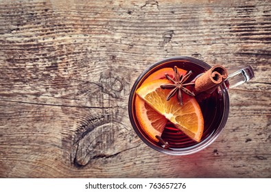 Hot Mulled Wine With Spices On Old Wooden Background. Top View