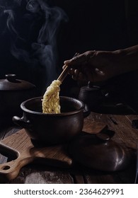 hot noodles in an earthenware bowl - Shutterstock ID 2364629991