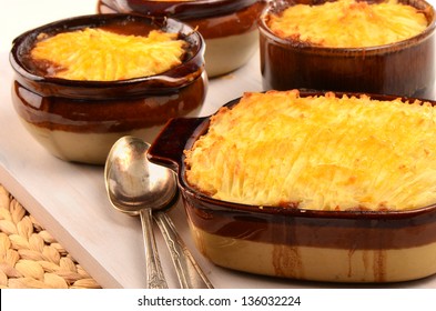 Hot From The Oven Homemade Shepherd's Pie With Cheesy Mashed Potatoes In Small Casserole Dishes