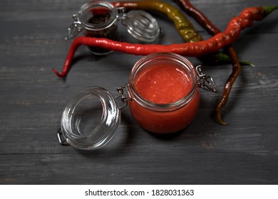 Hot Pepper Sriracha Sauce On A Dark Background Is A Dish Of Thai Cuisine . Horizontal Orientation