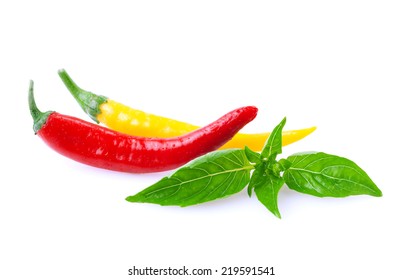 Hot peppers with basil leaf on white. - Shutterstock ID 219591541