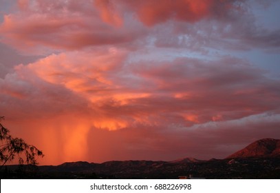  Hot Pink Fuchsia, Orange And Purple Monsoon Clouds Pouring Down Pink Rain At Sunset Over The Catalina Mountains In Silhouette In The Tucson Arizona Desert