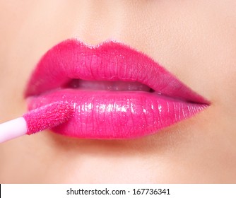 Hot Pink Lipstick. Lip Gloss On Sexy Lips And Brush. Makeup.