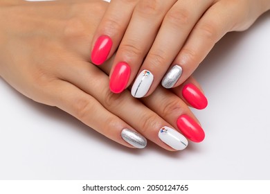 Hot Pink, White, Silver Manicure, With Silver Stripes And Crystals On The Nameless Nails. Short Oval Nails. Close-up On A White Background.