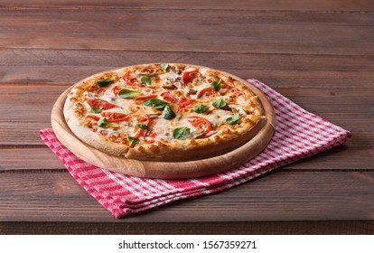 Hot pizza on wooden table