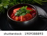 Hot red beet Kubbeh soup, a famous middle eastern dumplings soup dish, served in a bowl. A Jewish-Iraqi traditional matfuniya winter soup. Levantine dish made of bulgur, minced onions, ground  beef