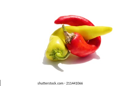 A Hot Red and Yellow Pepper entangle in an erotic embrace isolated on white with room for your text. Peppers are known as Aphrodisiacs around the world by various people and cultures. 