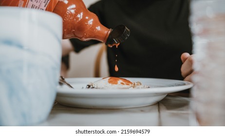 Hot Sauce Pour Action Shot