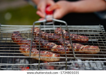 Hot sausages on the grill.. Ho sausage grilling outdoors on a barbecue grill.