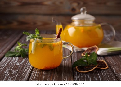 Hot sea buckthorn tea with mint, cinnamon and honey, a delicious preventive measure for colds, and to strengthen the immune system. - Shutterstock ID 1553084444