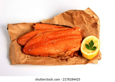 Hot smoked salmon trim and leftovers with bones and fins on white background - Shutterstock ID 2178184425