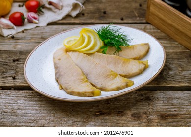 Hot Smoked Sliced Sturgeon Fillet On Old Wooden Table