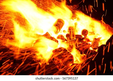 Hot sparking live-coals burning in a barbecue - Shutterstock ID 567395137
