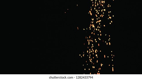 Hot Sparks Slowly Falling From Above Black Background