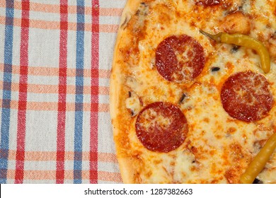 Hot, Spicy Pepperoni Pizza. Pizza On Classic Checkered Tablecloth Texture