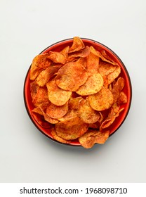 Hot Spicy Potato Chips Bowl Isolated On White, In Red Bowl. Fast Food, Junk Food Concept, Beer Snack. Potato Chips In Hot Spices. Copy Space Banner.