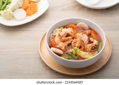 Hot And Spicy Soup With Mixed Vegetable(radish,yardlong Bean,Katuri Flower,carrot,cabbage) And Shrimp In White Bowl.Thai Traditional Healthy Menu And Diet Food.