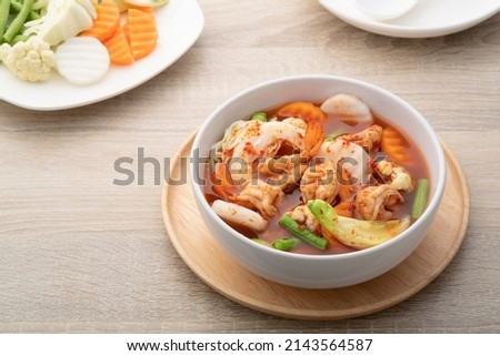 hot and spicy soup with mixed vegetable(radish,yardlong bean,Katuri Flower,carrot,cabbage) and Shrimp in white bowl.Thai traditional healthy menu and diet food.