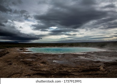 Hot Spring At The Geysir Site In Central Iceland. The Water Is Heated By Geothermal Energy And Gives Off A Slight Egg-like Smell From The Sulfur Rising From The Earth