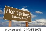 Hot Springs National Park (Arkansas) Road Sign Against Blue Sky and Clouds.