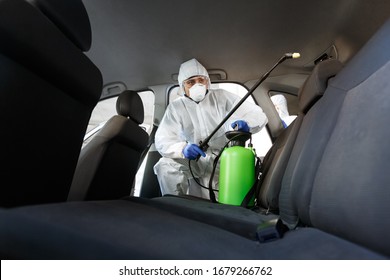 Hot steam disinfection of car seats in coronavirus hazmat, copy space for text