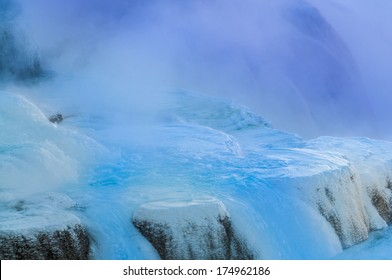 Hot steaming water beautiful cascade geyser - winter landscape in Yellowstone National Park