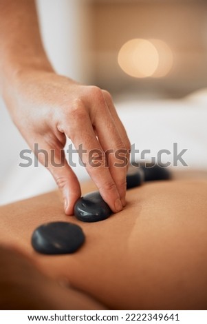 Hot stone therapy, massage and relax in a luxury spa resort for wellness treatment, relaxation therapy with hand and organic healing. Woman in a beauty salon, natural skincare and body health energy