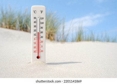 Hot Summer Day. Celsius And Fahrenheit Scale Thermometer In The Sand. Ambient Temperature Plus 18 Degrees 