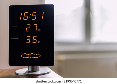 Hot Summer Day. High Temperatures Showing On Display Of Home Meteo Station. Sun Shine Through Window.