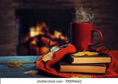 Hot Tea And Book With Autumn Leaves On Wood Background - Seasonal Relax Concept.