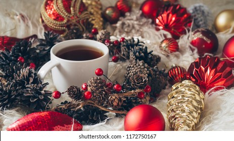 Hot tea and Christmas toys on a warm background of natural warm sheepskins. New Year 2019 composition. Flat lay, top view of New Year 2019 festive still life. - Powered by Shutterstock