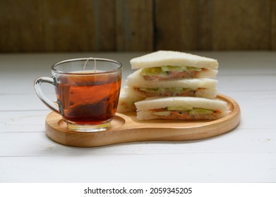 Hot Tea with Tuna Sandwich on wooden plate wood background - Shutterstock ID 2059345205