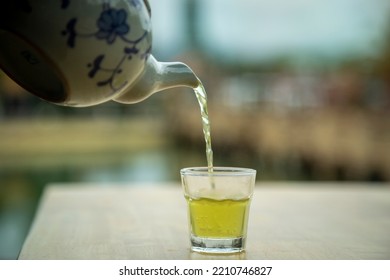 Hot Teapot Pouring Tea Into A Glass, Close-up