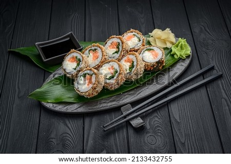 Hot tempura roll with salmon and cheese, Traditional delicious fresh sushi roll set on a black background. Sushi menu. Japanese kitchen, restaurant. Asian food Stockfoto © 