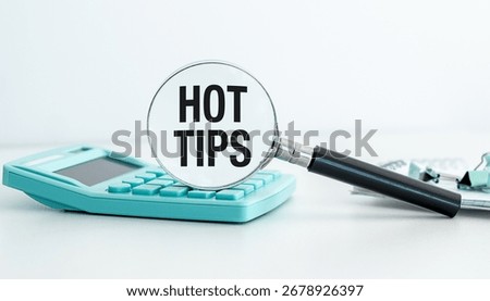 Hot Tips concepts with calculator using magnifying glass with Hot Tips text icon on white background.