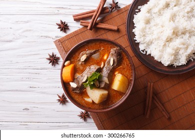 Hot Traditional Thai Beef Massaman Curry With Peanuts And Rice Side Dish. Horizontal View From Above
