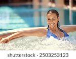 Hot tub, happy and portrait of woman at hotel for summer vacation, holiday and weekend to relax. Luxury spa, getaway and person in swimsuit in heated water for wellness, health and detox at resort