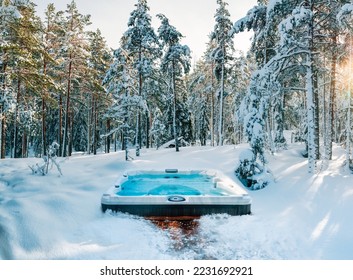 Hot tub in the middle of a beautiful winter forest. Nothing is more relaxing than a soak in a hot tub on a cold winter's day. - Shutterstock ID 2231692921