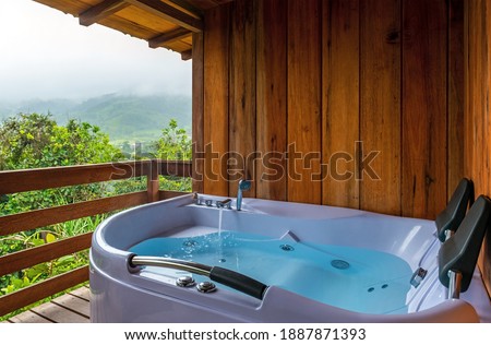 Hot tub on a balcony with view over the cloud forest, Mindo, Ecuador.