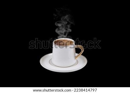Hot Turkish coffee on black background, steam coming out of freshly cooked.